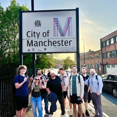 Our team stood under a Manchester sign